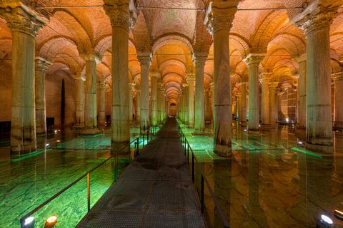 Yeşil ışıkla aydınlanan su ve ortadaki uzun yürüme yolu